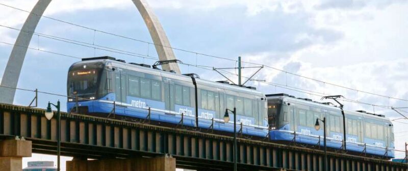 3D rendering of a next generation MetroLink vehicle going across the Mississippi river, with the Gateway Arch behind it